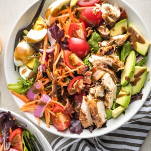 Bowl of healthy Cobb salad with balsamic grilled chicken.