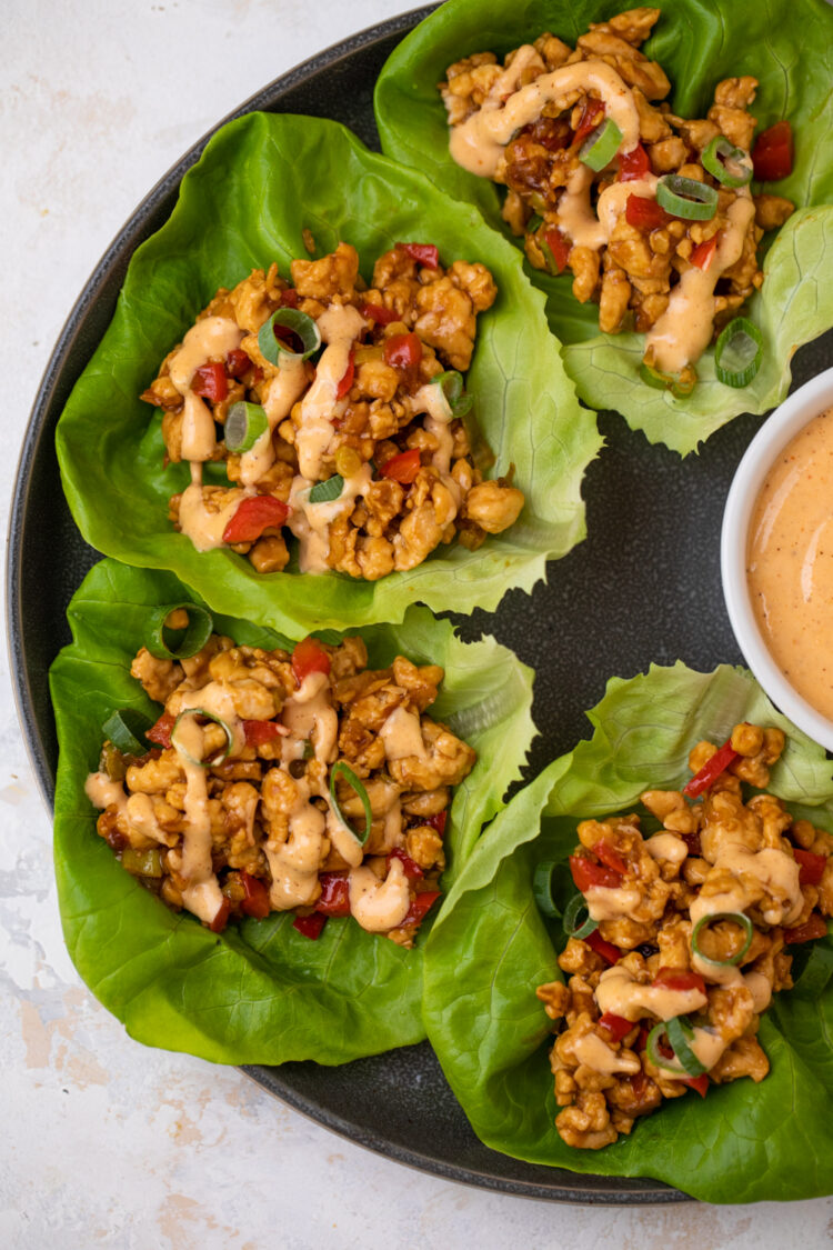 plate full of asian chicken lettuce wraps with sauce