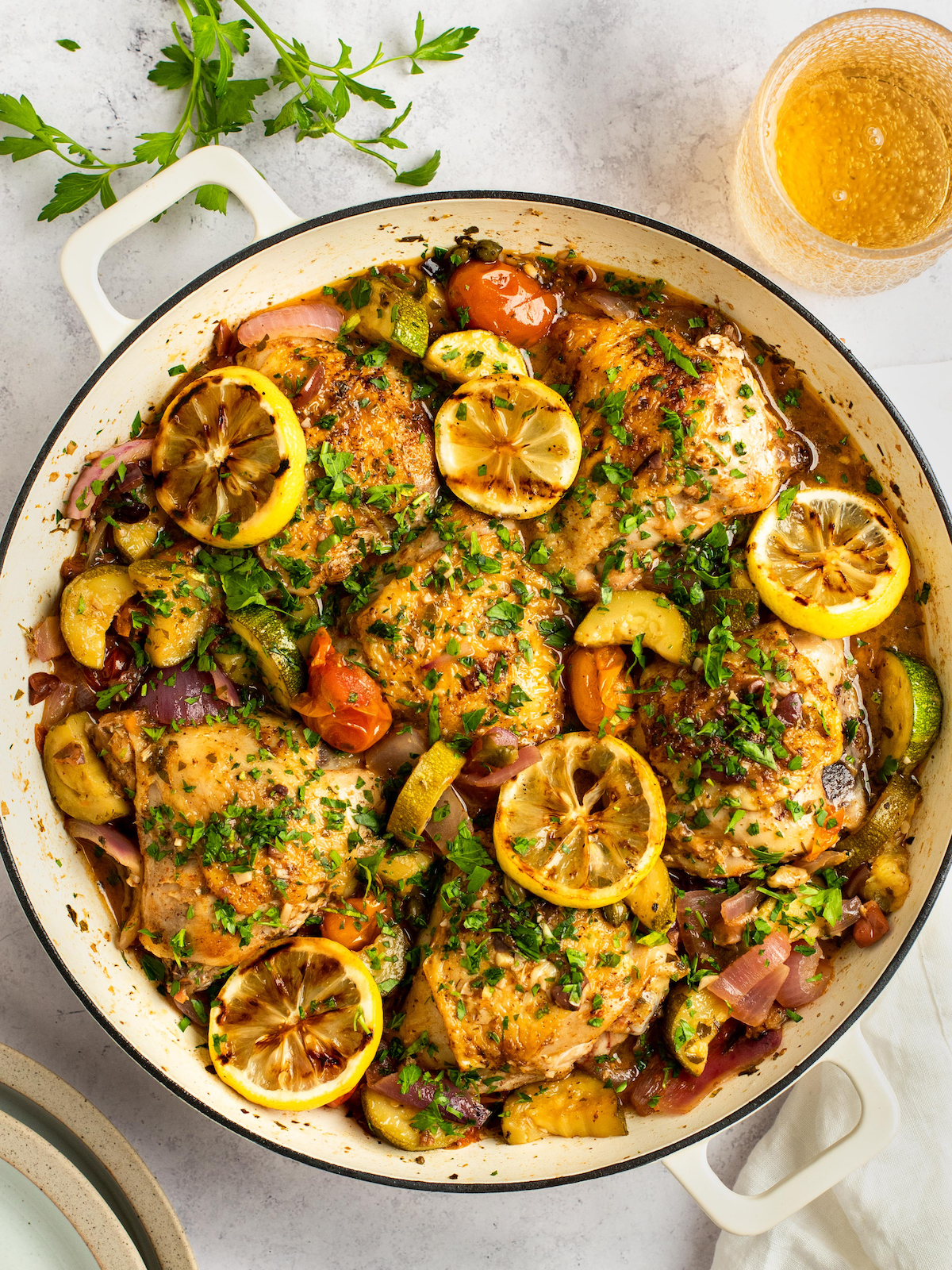 Mediterranean Chicken in a large pot with lemon slices.