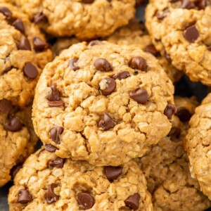 Chocolate chip cookies stacked on top of one another.