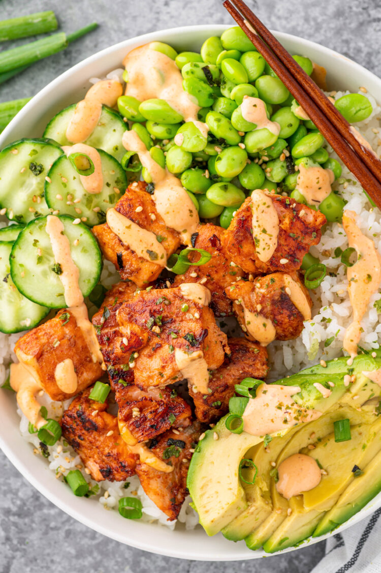 Salmon Maki bowl assembled with rice, salmon, avocado, cucumbers, edamame and spicy mayo.