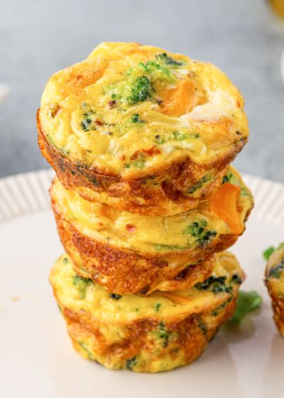 Three egg muffins stacked on a plate.