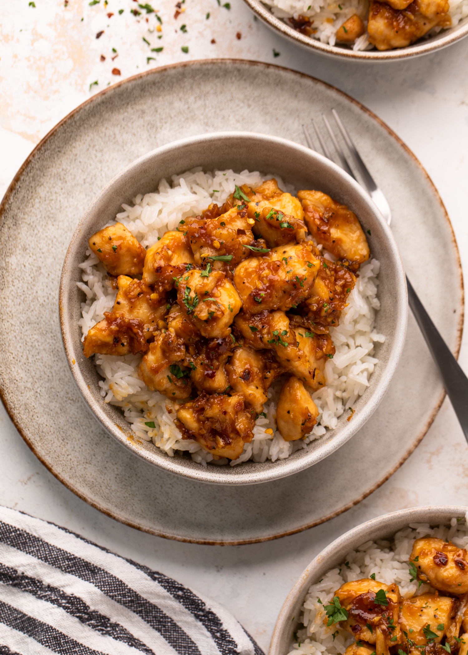 Chicken bites in a sticky sauce over white rice.